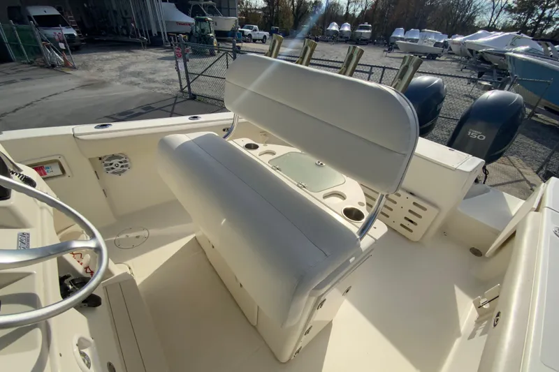 Slide: The Image of 2005 Pursuit 2570 Center Console boat interior with seating and dual engines. - 10