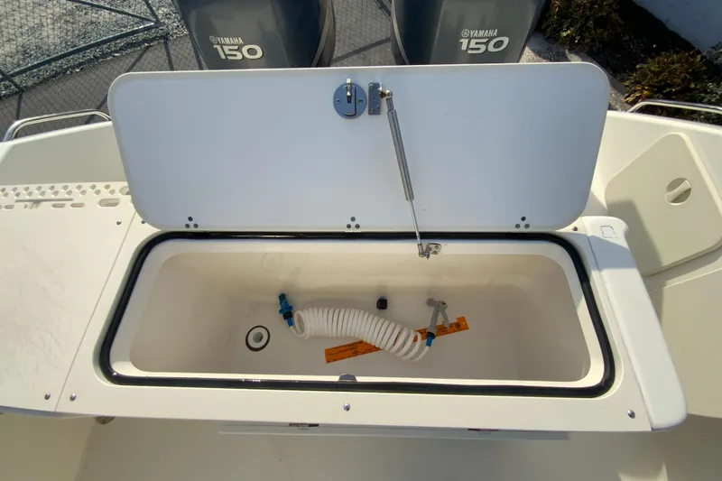 Slide: The Image of Open storage compartment on 2005 Pursuit 2570 Center Console boat with Yamaha 150 engines. - 11