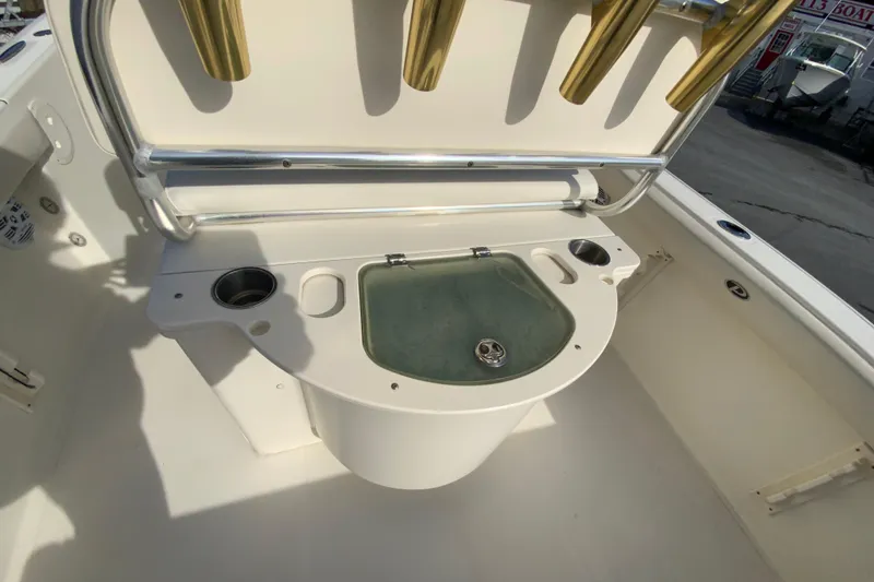 Slide: The Image of 2005 Pursuit 2570 Center Console boat with livewell and rod holders. - 12