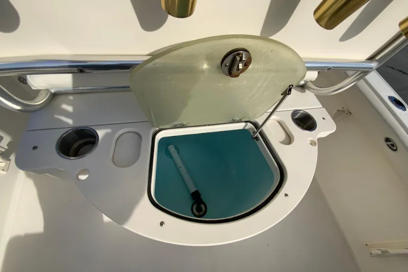 Slide: The Image of Livewell on a 2005 Pursuit 2570 Center Console boat, open with blue interior. - 13