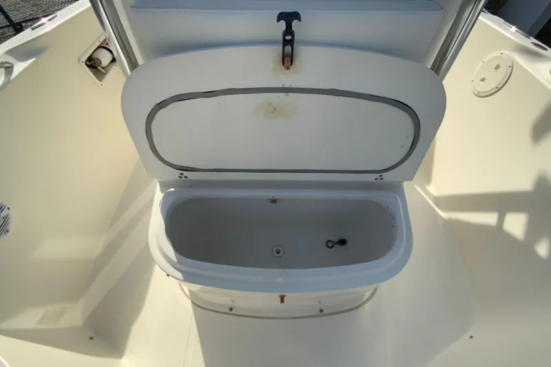 Slide: The Image of Open storage compartment on 2005 Pursuit 2570 Center Console boat. - 16