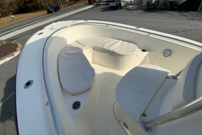 Slide: The Image of 2005 Pursuit 2570 Center Console boat with cushioned seating in the bow area. - 17