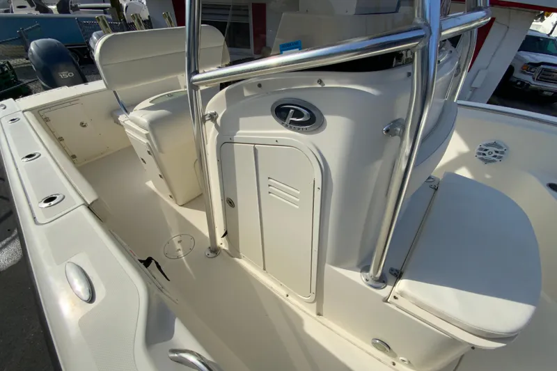 Slide: The Image of 2005 Pursuit 2570 Center Console boat interior with seating and storage. - 22