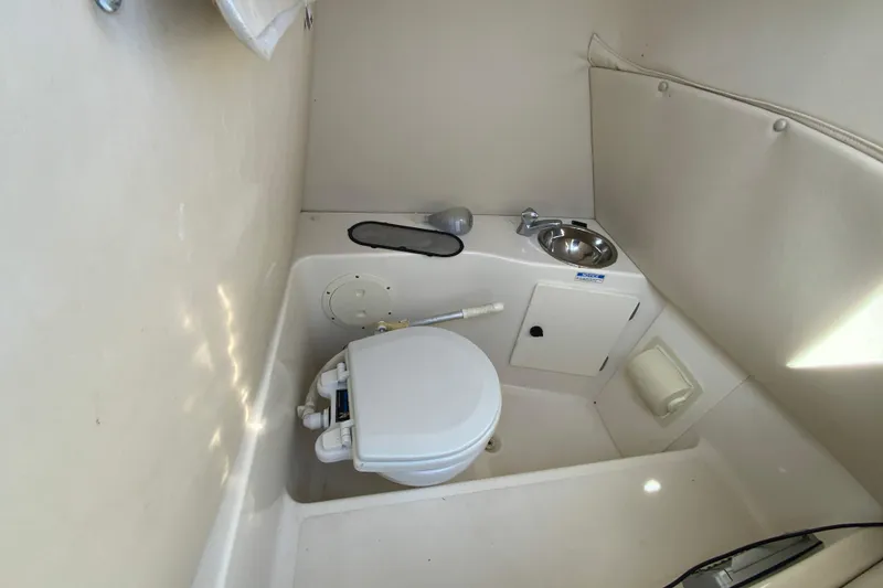 Slide: The Image of Compact marine bathroom in a 2005 Pursuit 2570 Center Console boat. - 24