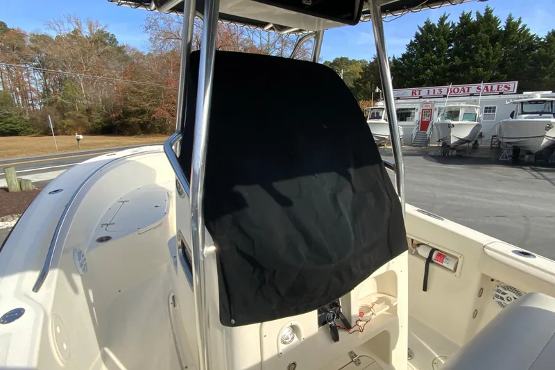 Slide: The Image of 2005 Pursuit 2570 Center Console boat at dealership, showcasing helm and seating area. - 25