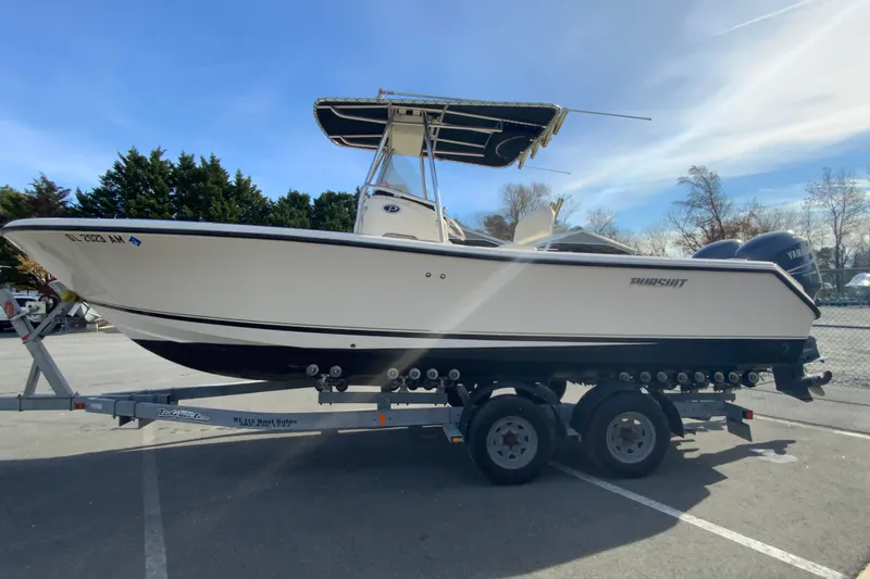 Slide: The Image of 2005 Pursuit 2570 Center Console boat on trailer, parked outdoors. - 6
