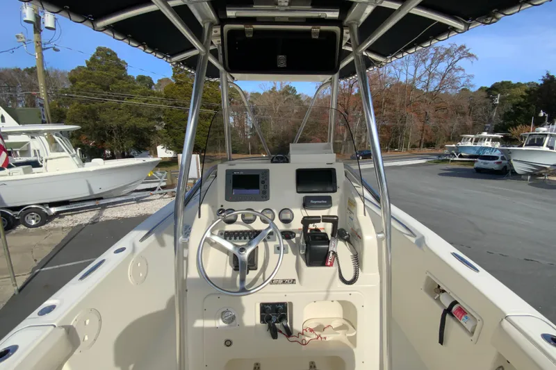 Slide: The Image of 2005 Pursuit 2570 Center Console boat interior with steering wheel and navigation equipment. - 7