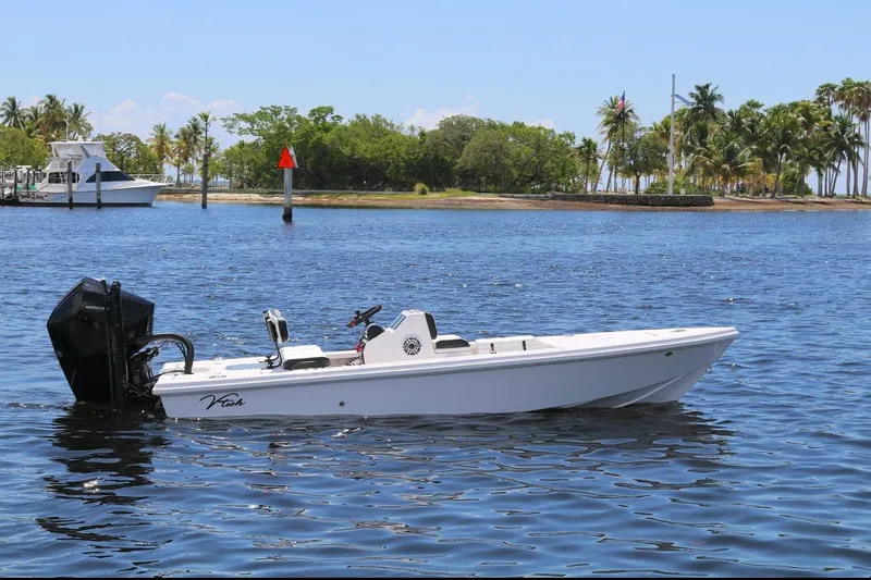 The Image of 2024 Vtech 18 boat on calm water with tropical island background. - 0
