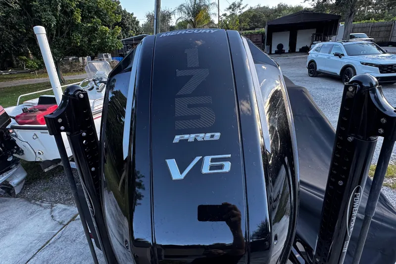 Slide: The Image of Black Mercury 175 Pro V6 outboard motor on a boat, Vtech 18, 2024 model. - 11