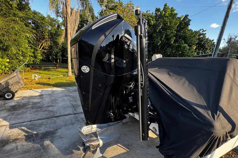 Slide: The Image of Outdoor view of a 2024 Vtech 18 boat engine, parked on a driveway. - 15