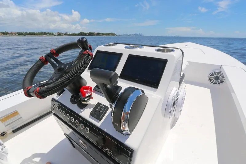 Slide: The Image of Steering console of 2024 Vtech 18 boat with modern controls on open water. - 4