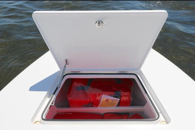 Slide: The Image of Open storage compartment on Vtech 18 boat, 2024 model, with life jackets inside. - 7