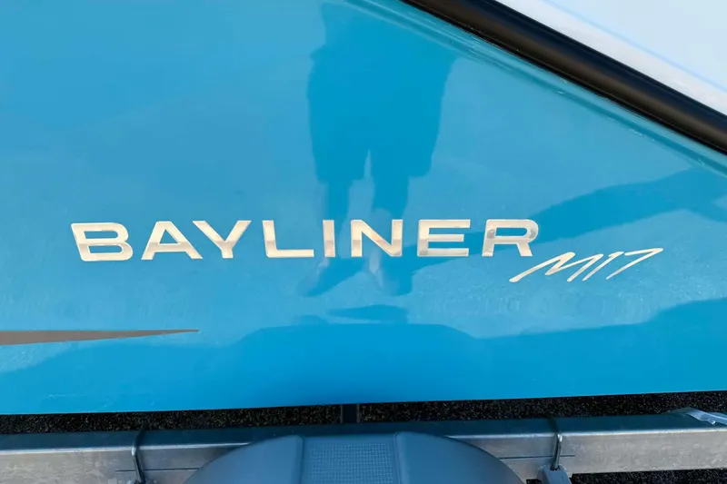 Slide: The Image of 2026 Bayliner M17 boat logo on a blue hull. - 1