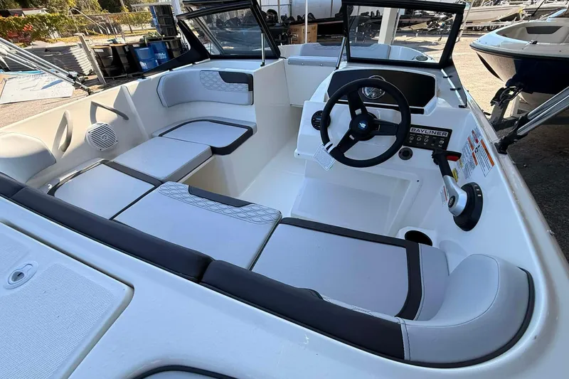Slide: The Image of 2026 Bayliner M17 boat interior with modern seating and steering console. - 3