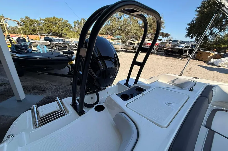 Slide: The Image of 2026 Bayliner M17 boat with sleek design, outboard motor, and comfortable seating in a marina setting. - 8