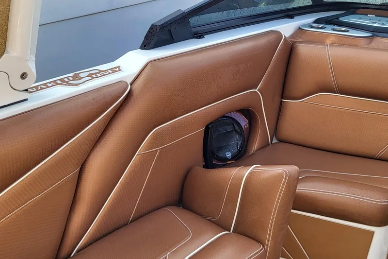 Slide: The Image of 2021 Centurion Ri265 boat interior with brown leather seating and speaker detail. - 12