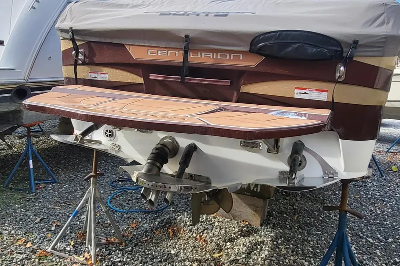Slide: The Image of 2021 Centurion Ri265 boat on stands, rear view with covered deck. - 16