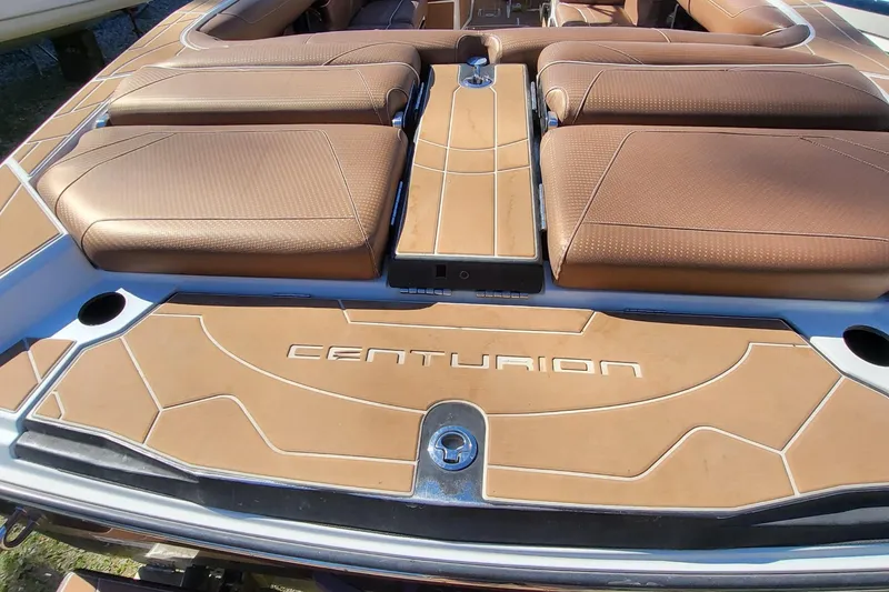 Slide: The Image of 2021 Centurion Ri265 boat interior with tan upholstery and logo detailing. - 18