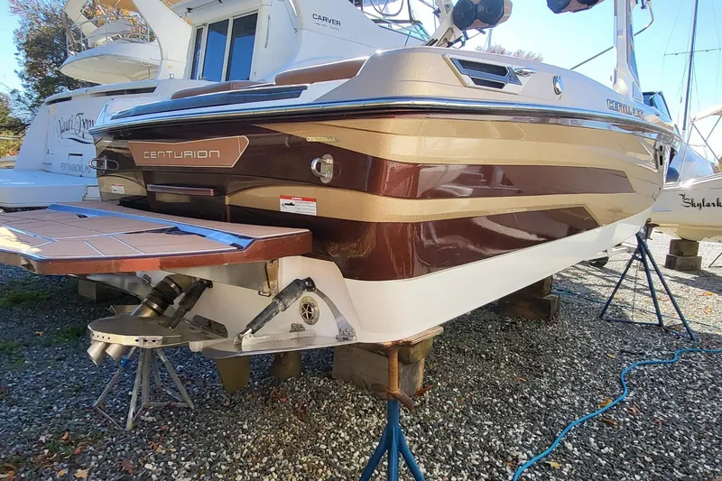 Slide: The Image of 2021 Centurion Ri265 boat on stands, showcasing sleek design and vibrant colors. - 3