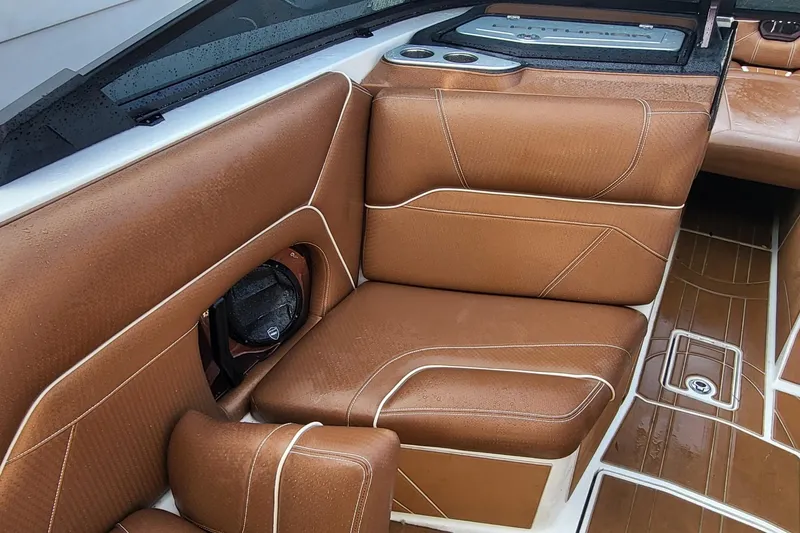 Slide: The Image of 2021 Centurion Ri265 boat interior with brown leather seating and modern design. - 8