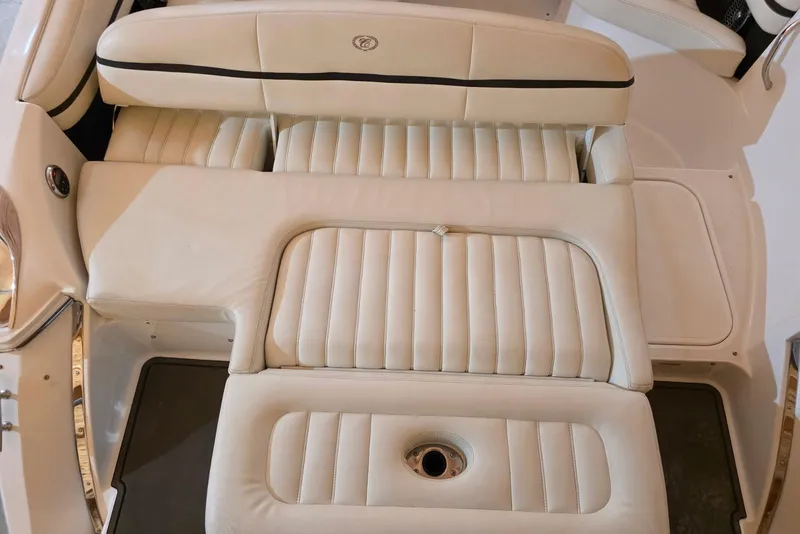 Slide: The Image of 2014 Cobalt R5 boat interior with white leather seating and cup holder. - 11