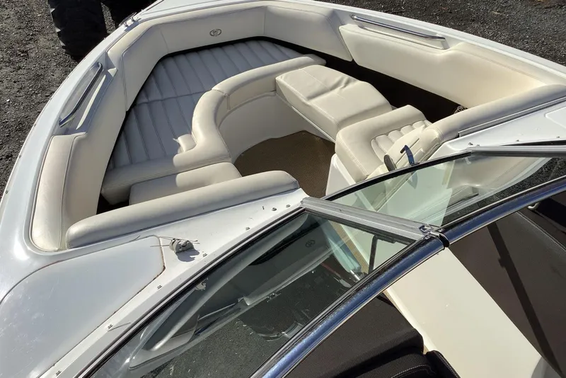 Slide: The Image of 2014 Cobalt R5 boat interior with white leather seating and open bow design. - 12