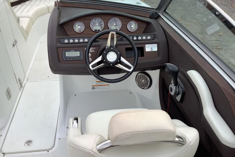 Slide: The Image of 2014 Cobalt R5 boat dashboard with steering wheel and control panel. - 14