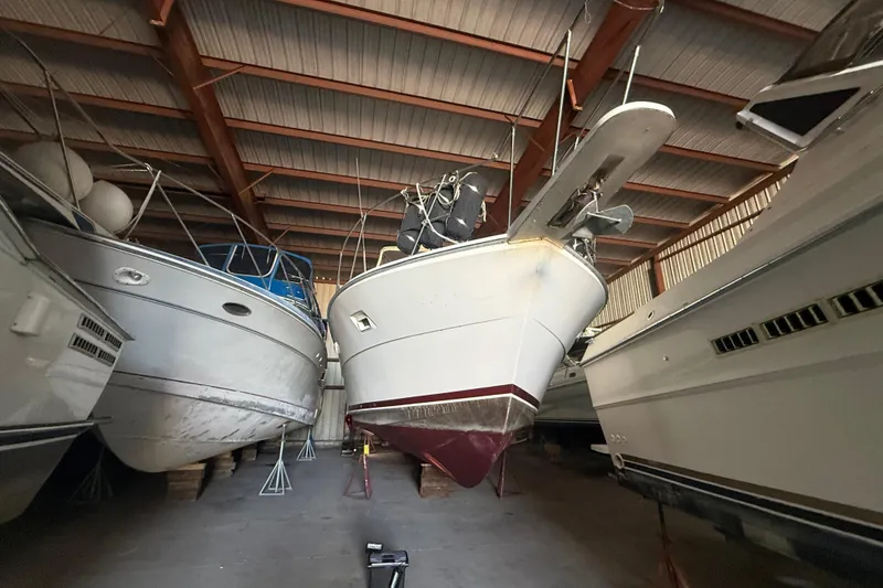 Slide: The Image of 1984 Viking 44 Motor Yacht stored in a boatyard, surrounded by other vessels. - 10