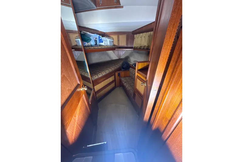 Slide: The Image of Interior of 1984 Viking 44 Motor Yacht with wooden cabinetry and cozy sleeping area. - 100