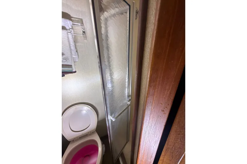 Slide: The Image of Bathroom interior of 1984 Viking 44 Motor Yacht with shower and toilet. - 106