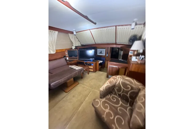 Slide: The Image of Interior of 1984 Viking 44 Motor Yacht with cozy seating and entertainment area. - 108