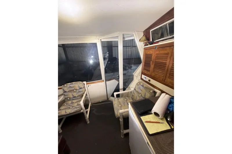 Slide: The Image of Interior of 1984 Viking 44 Motor Yacht with chairs and wooden cabinets. - 111