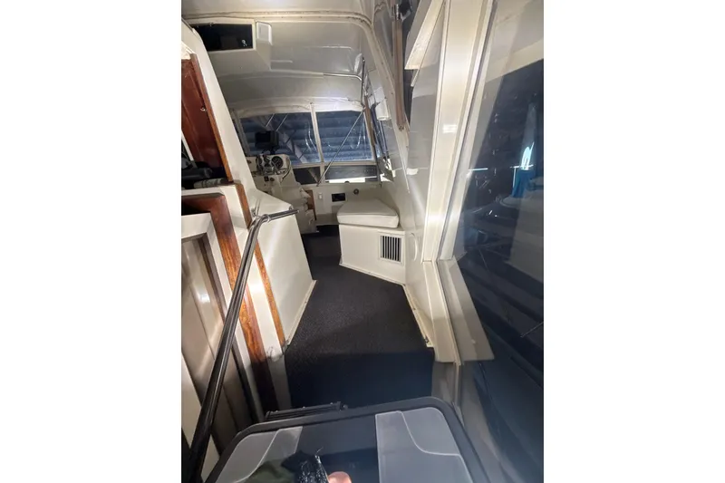 Slide: The Image of Interior view of 1984 Viking 44 Motor Yacht, showcasing helm and seating area. - 112