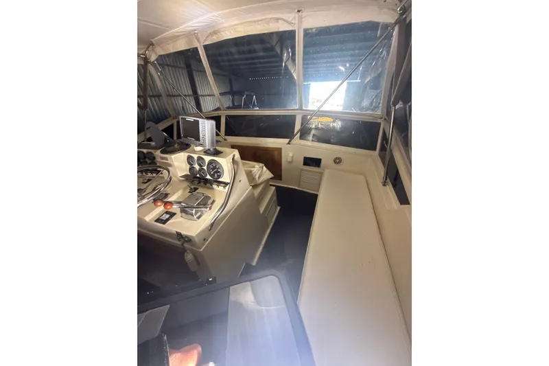 Slide: The Image of 1984 Viking 44 Motor Yacht interior helm with navigation instruments and seating. - 114