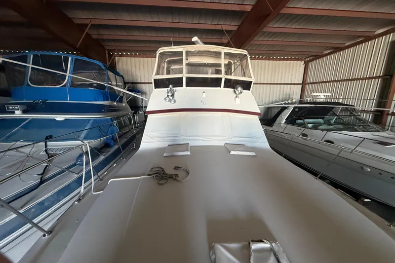 Slide: The Image of 1984 Viking 44 Motor Yacht in storage, surrounded by other boats. - 115