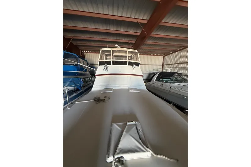 Slide: The Image of 1984 Viking 44 Motor Yacht in storage, showcasing sleek design and spacious deck. - 116
