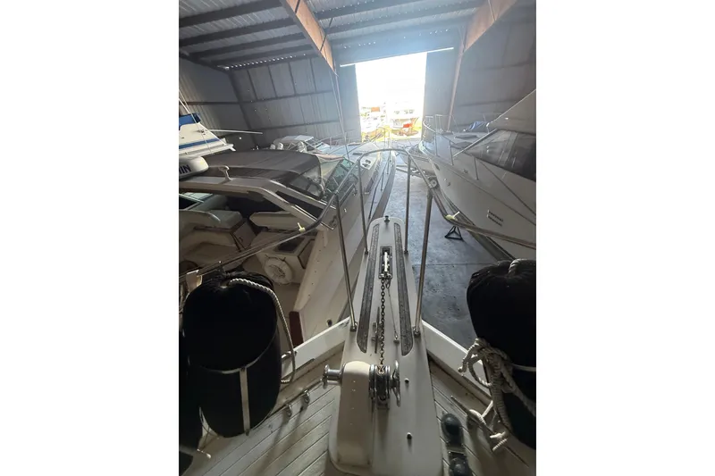 Slide: The Image of 1984 Viking 44 Motor Yacht in storage, showcasing deck and anchor chain. - 118