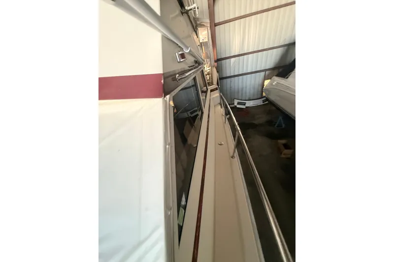 Slide: The Image of 1984 Viking 44 Motor Yacht side view in storage, showcasing sleek design and railing. - 120