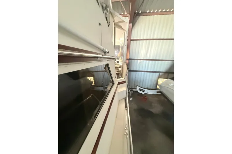 Slide: The Image of 1984 Viking 44 Motor Yacht in storage, side view with windows and railing. - 123