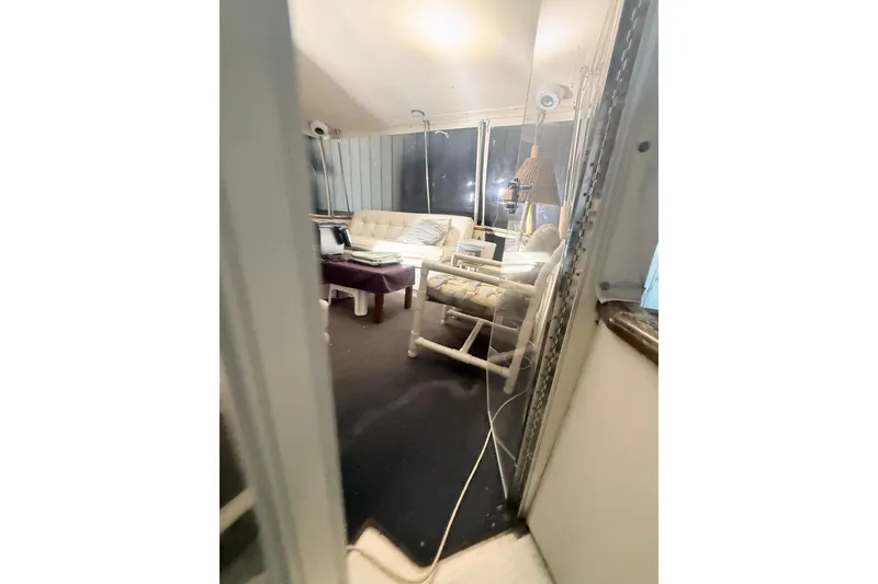 Slide: The Image of Interior of 1984 Viking 44 Motor Yacht with cozy seating and decor. - 124