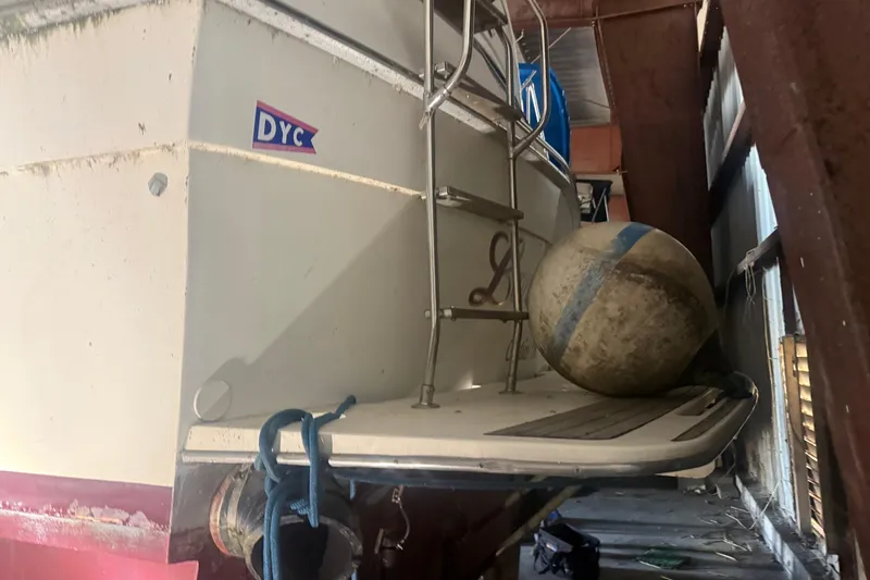 Slide: The Image of 1984 Viking 44 Motor Yacht in storage, featuring ladder and buoy. - 129