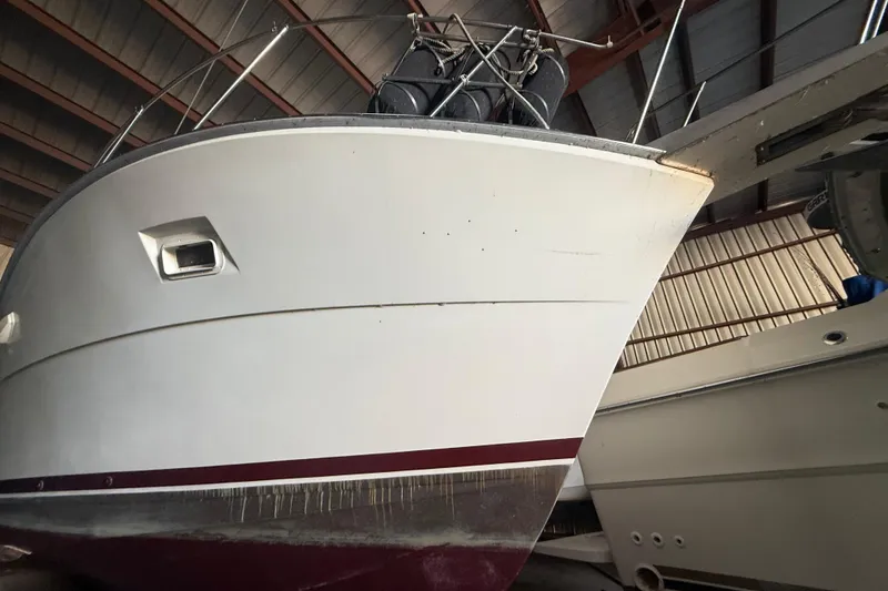 Slide: The Image of 1984 Viking 44 Motor Yacht in storage, showcasing its sleek hull design. - 13