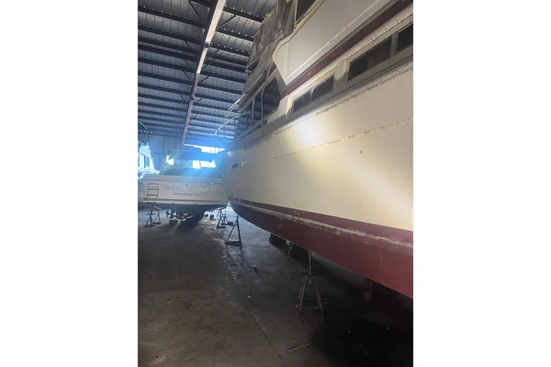 Slide: The Image of 1984 Viking 44 Motor Yacht in storage, side view, indoor facility. - 131