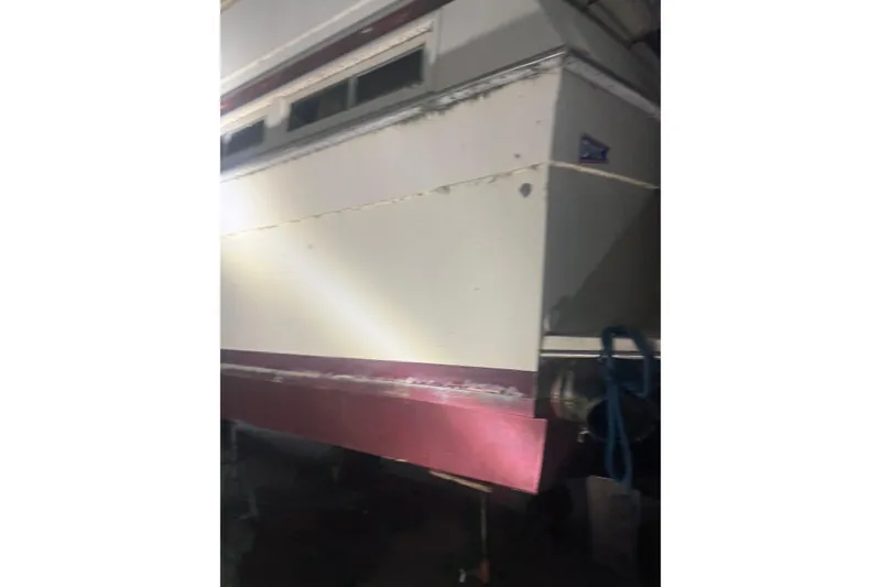 Slide: The Image of 1984 Viking 44 Motor Yacht, rear view, in storage with visible wear. - 132