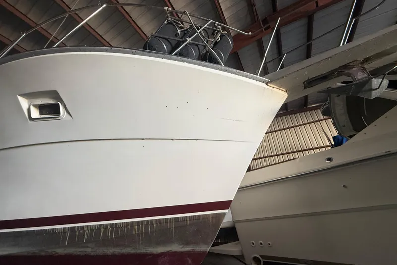 Slide: The Image of 1984 Viking 44 Motor Yacht in storage, showcasing its bow and sleek design. - 14