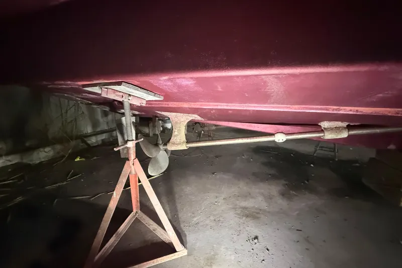 Slide: The Image of Underneath view of a 1984 Viking 44 Motor Yacht on a stand, showing propeller and hull. - 16