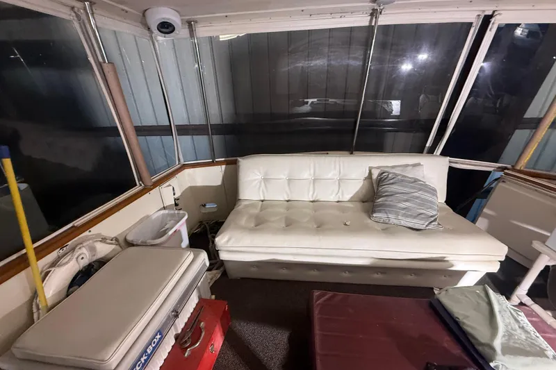Slide: The Image of Interior of 1984 Viking 44 Motor Yacht with white sofa and striped pillow. - 19