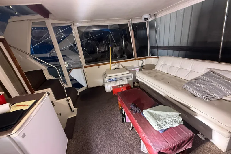 Slide: The Image of Interior of 1984 Viking 44 Motor Yacht with sofa, table, and cooler. - 20