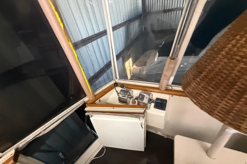 Slide: The Image of 1984 Viking 44 Motor Yacht interior with control panel and windows in storage. - 25