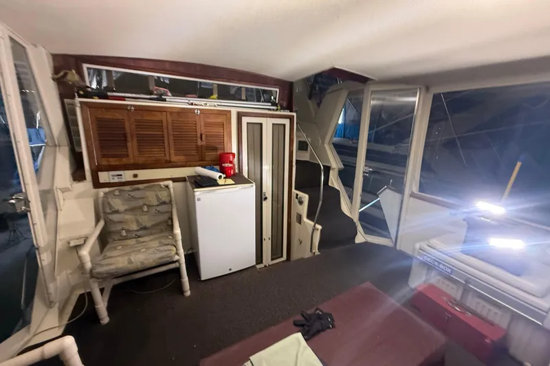Slide: The Image of Interior of 1984 Viking 44 Motor Yacht with seating, fridge, and storage. - 28